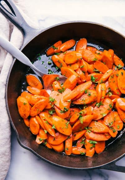 candied carrots served out of a skillet with brown sugar glaze
