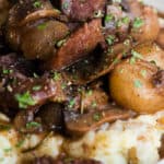 beef and mushrooms in gravy over mashed potatoes