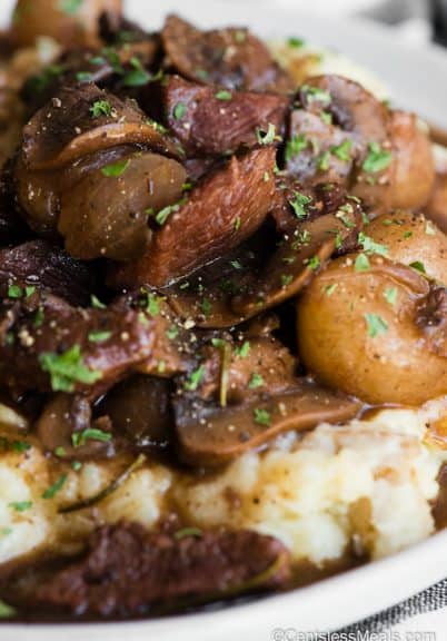 beef and mushrooms in gravy over mashed potatoes