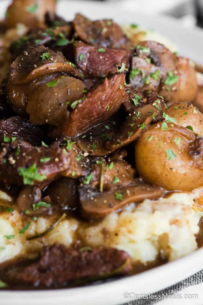 beef and mushrooms in gravy over mashed potatoes