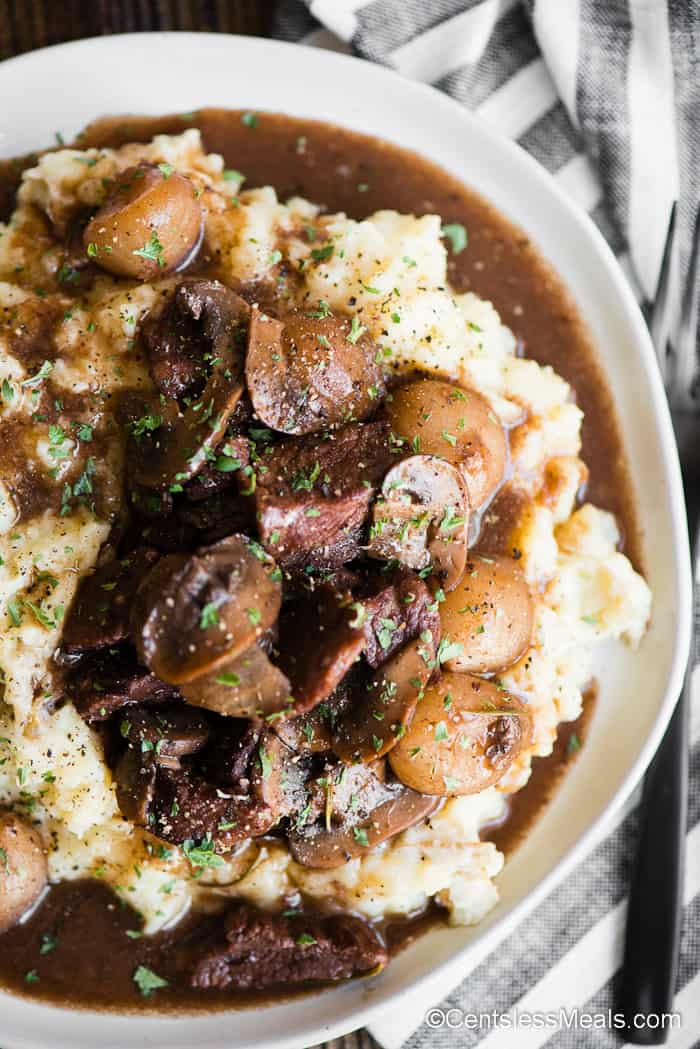 plate of mashed potatoes covered in beef burgandy