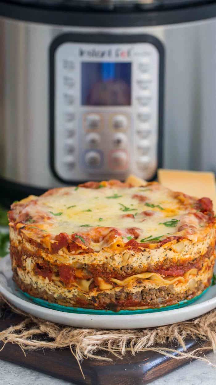 Instant pot lasagna on a plate with a instant pot in the background