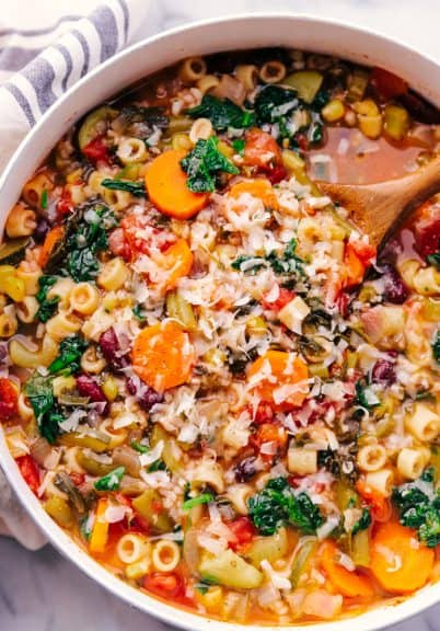 minestrone soup homemade in a stockpot garnished with parmesan cheese.