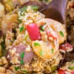 Jambalaya Recipe in a blue pot with a wooden spoon