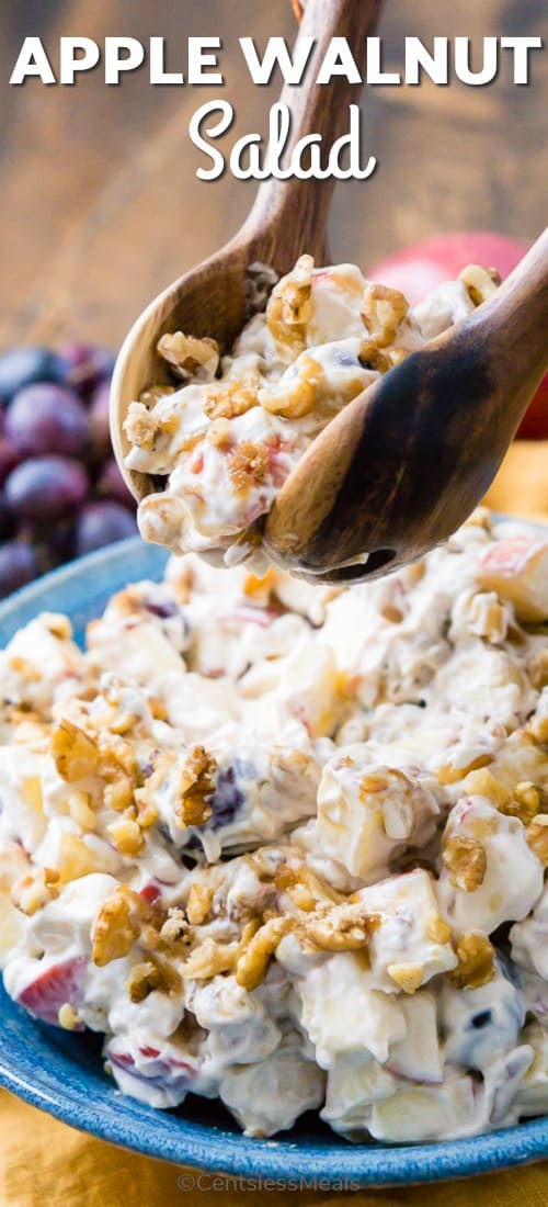 Apple walnut salad in a blue bowl with wooden utensils and a title