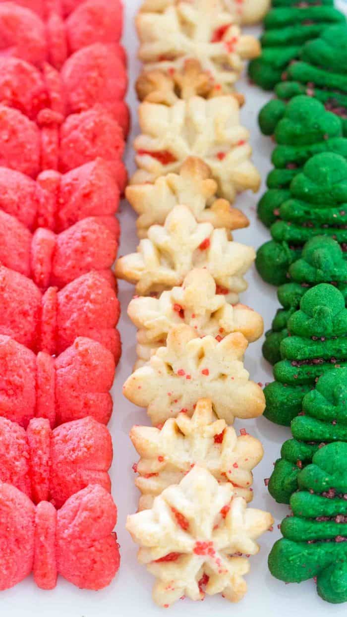 Red white and green spritz cookies lined up on a plate