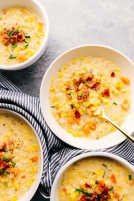 Crock-Pot corn chowder in white bowls with a spoon