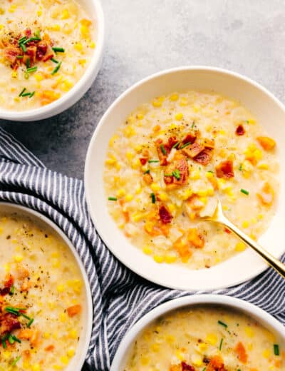 Crock-Pot corn chowder in white bowls with a spoon