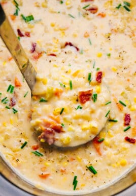 Crock-Pot corn chowder in a crock pot with a scoop being taken out