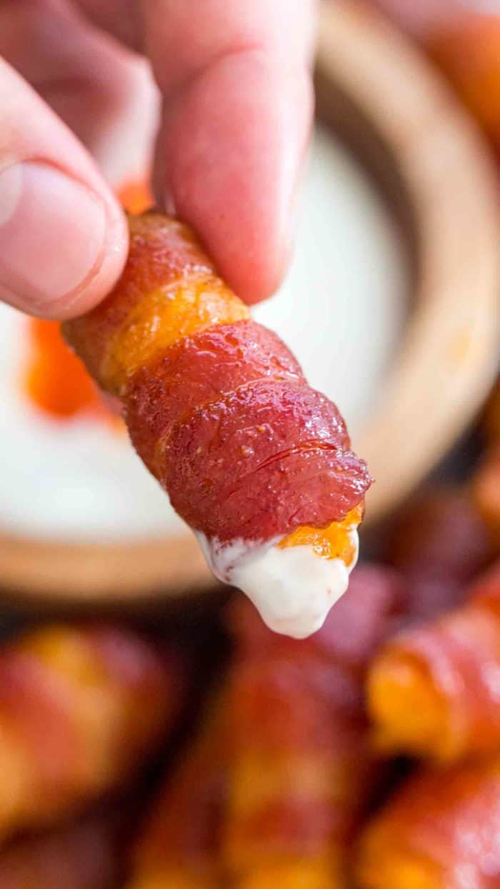 Bacon wrapped tater tot being dipped
