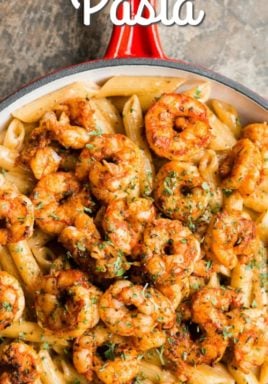 Cajun shrimp pasta in a pan with a title