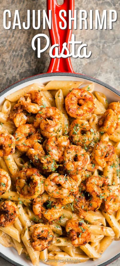 Cajun shrimp pasta in a pan with a title