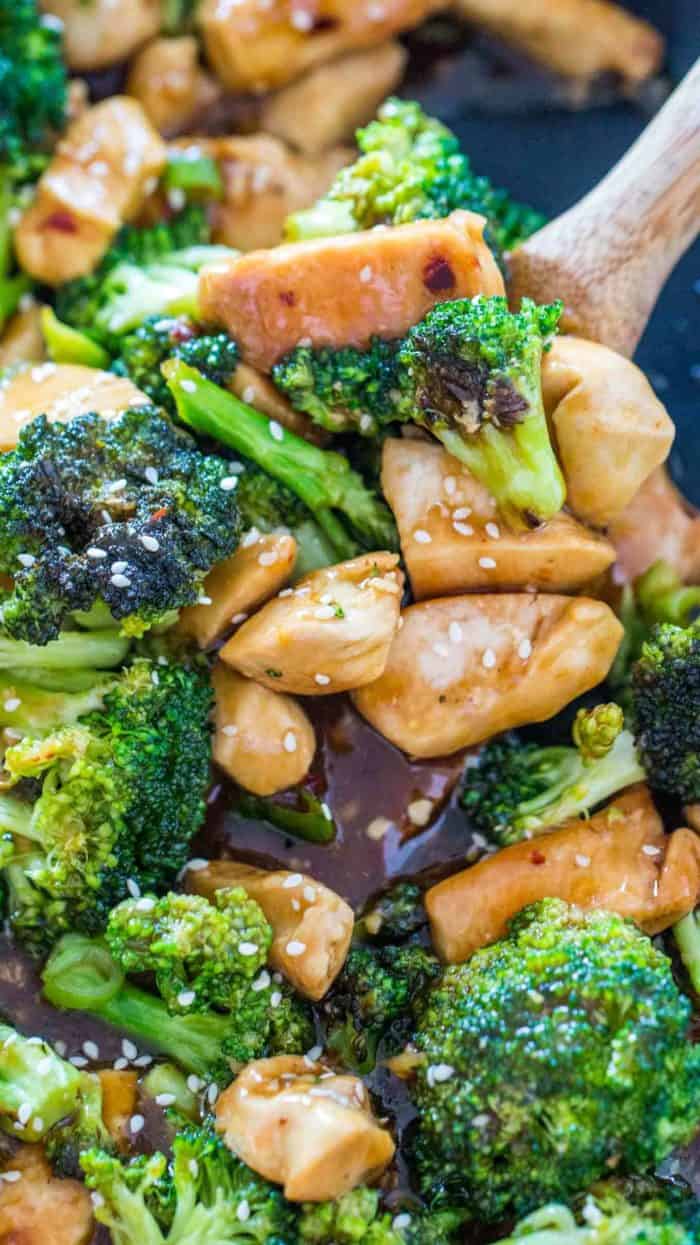 Chicken and broccoli with a wooden spoon