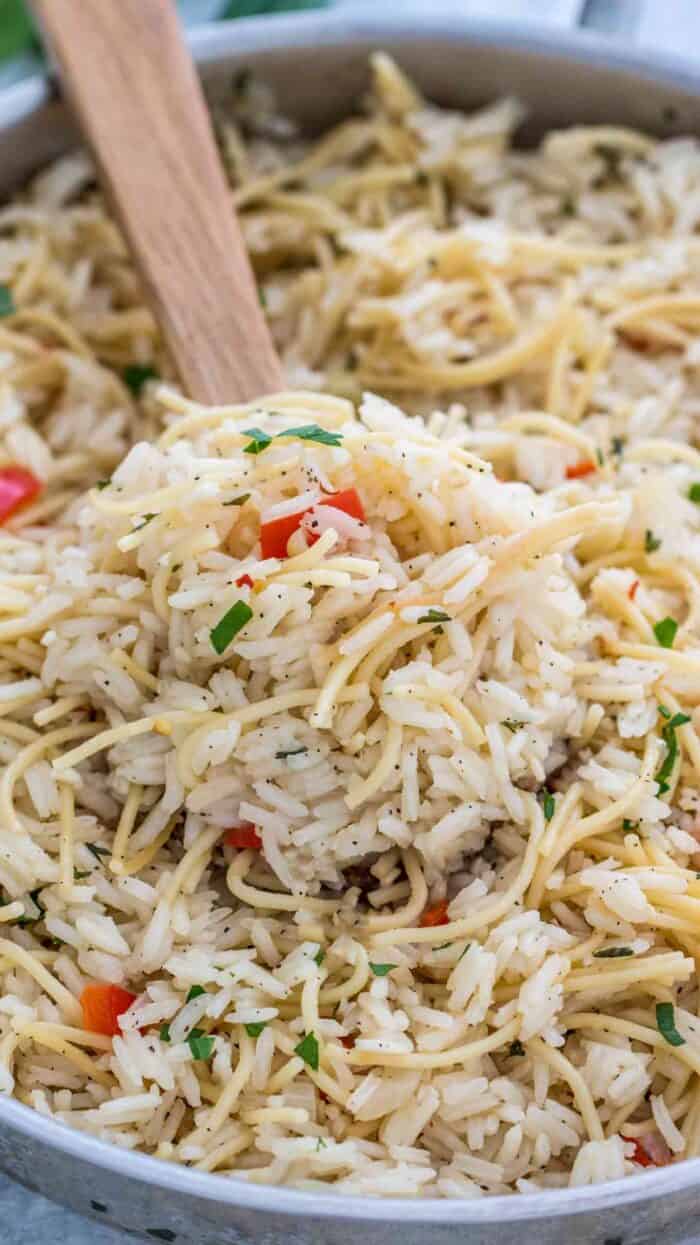 Rice a Roni in a pan with a wooden spoon