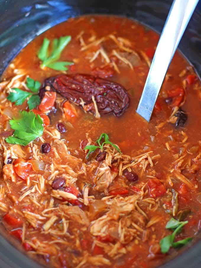 Slow Cooker Chicken Tortilla Soup in a slow cooker with a ladle