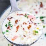 Slow Cooker Leek Soup in a ladle with a Crock-Pot in the background