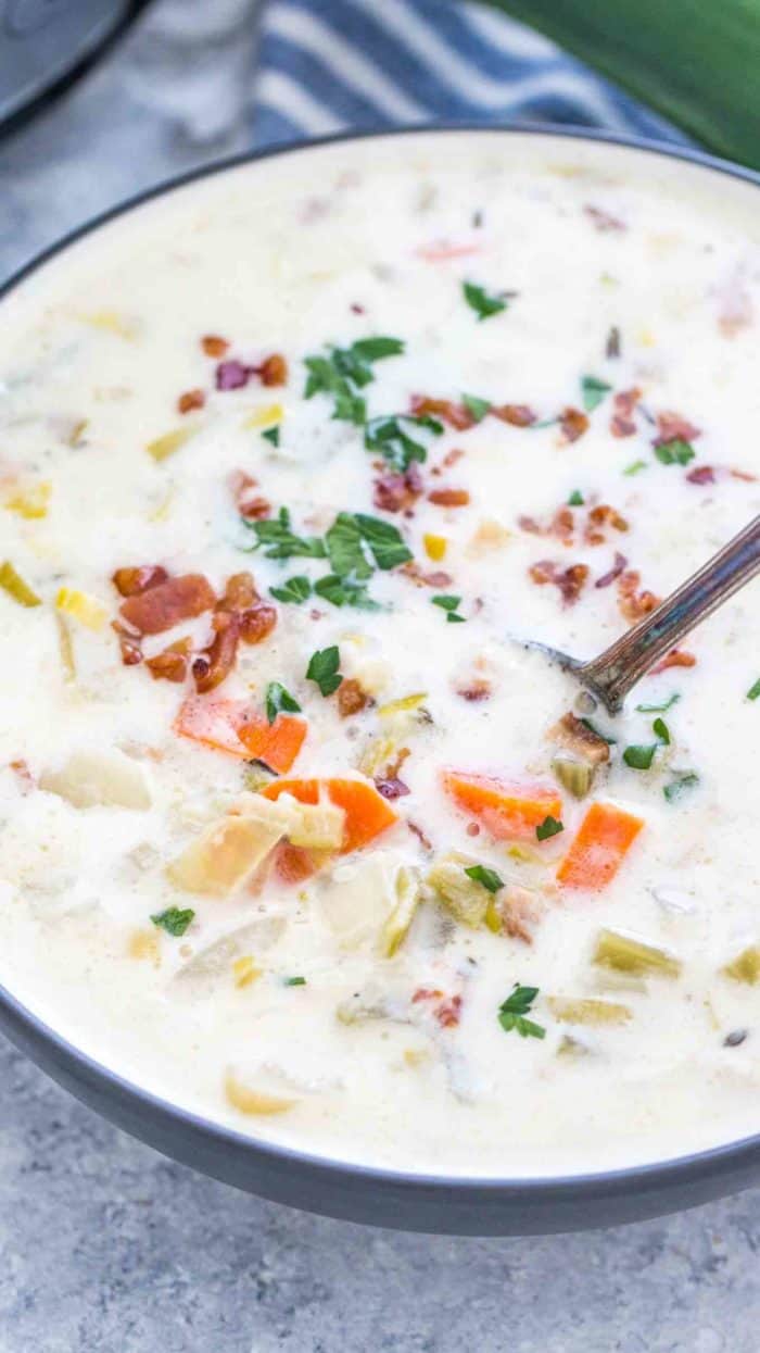 Slow Cooker Leek Soup in a bowl garnished parsley and bacon