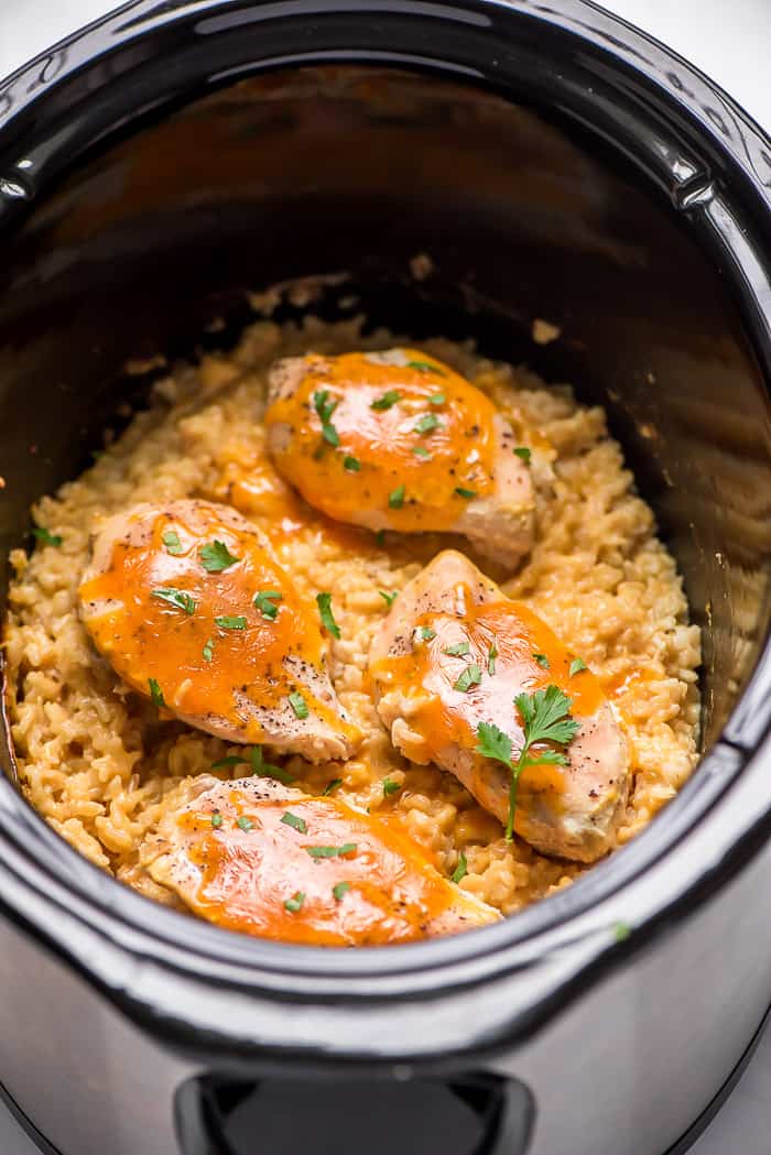 Crock-Pot cheesy chicken rice in a crock pot with parsley