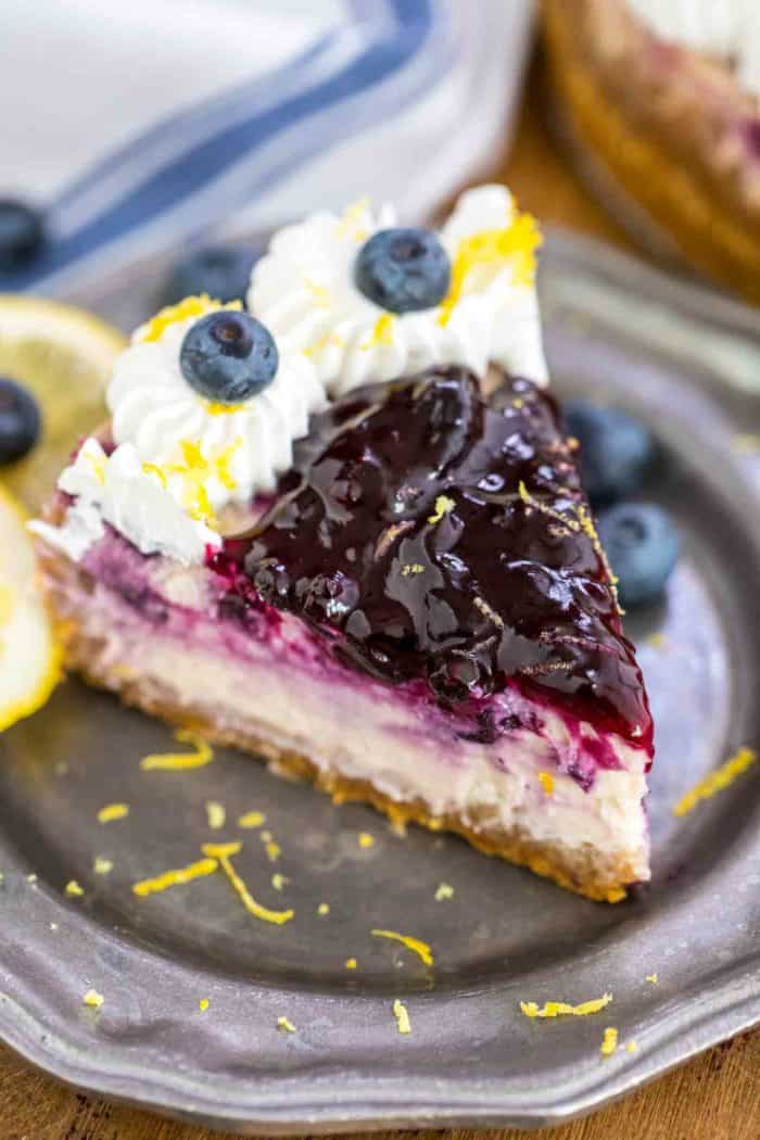 Blueberry Cheesecake Slice on a plate with lemon zest