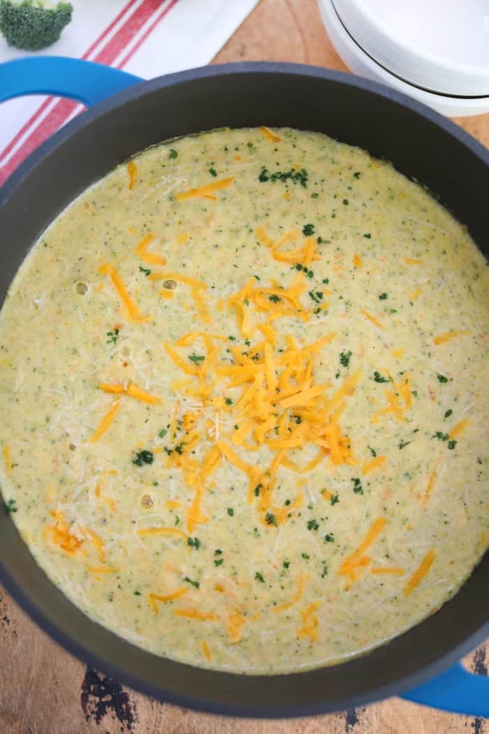 Broccoli Soup in a pot with shredded cheddar