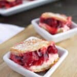 Cheesecake bake in white bowls on a wooden board