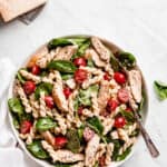 Chicken pasta salad in a bowl with a spoon