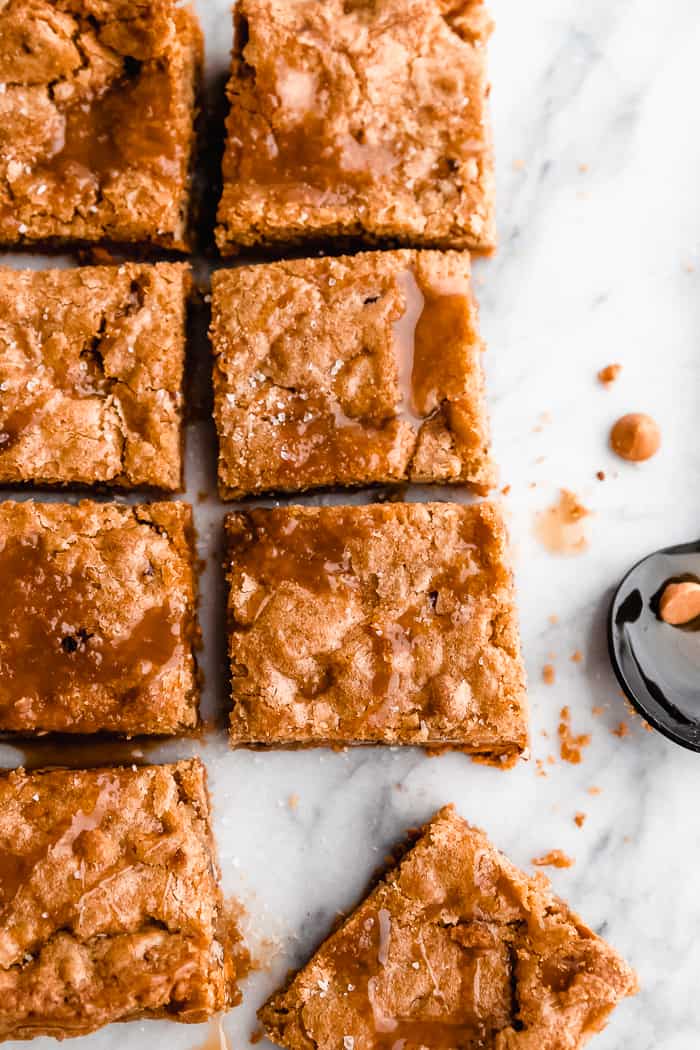 Squares of butterscotch Blondie's on a marble board