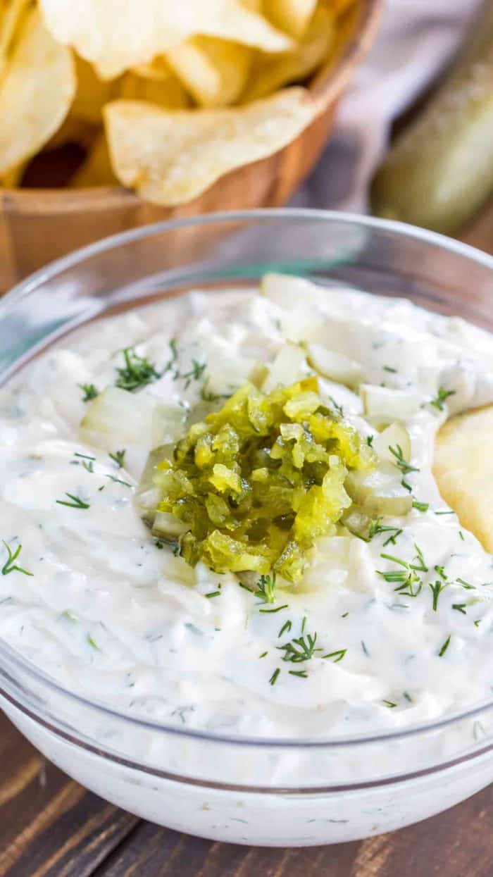 Dill Pickle Dip in a bowl garnished with dill and pickles