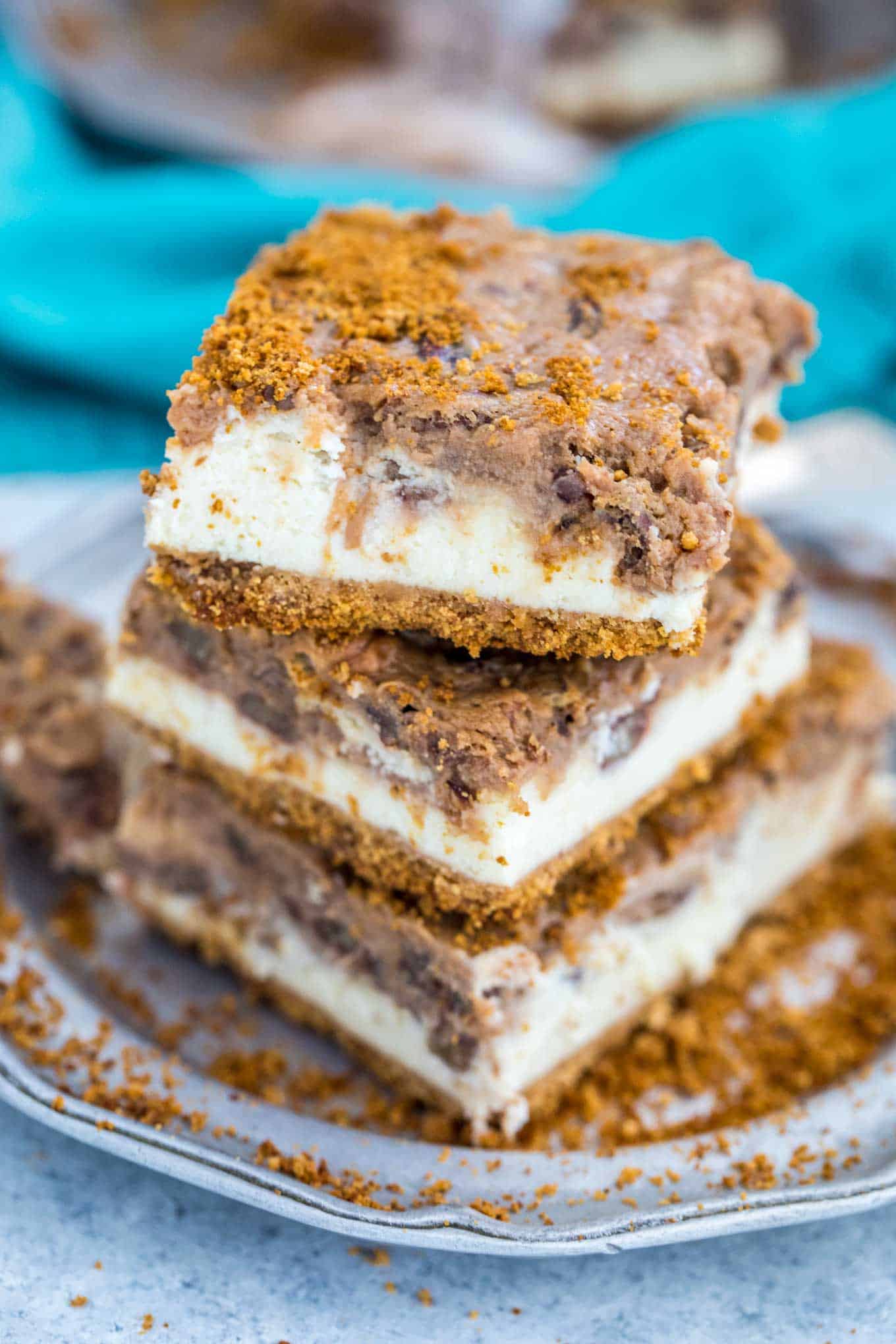 Stack of pecan pie cheesecake squares on a plate