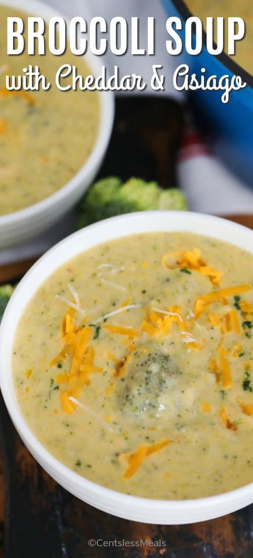 Broccoli soup with cheddar and Asiago in a white plate with shredded cheese and a title