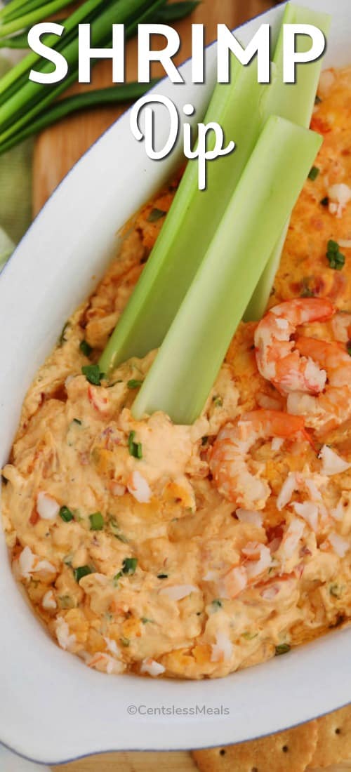 Shrimp dip in a dish with celery sticks and writing