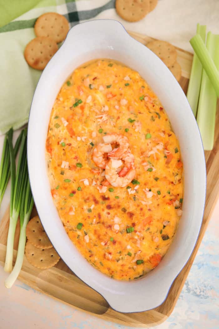 Shrimp dip in a white bowl with shrimp on top
