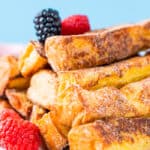 French toast sticks on a plate with berries