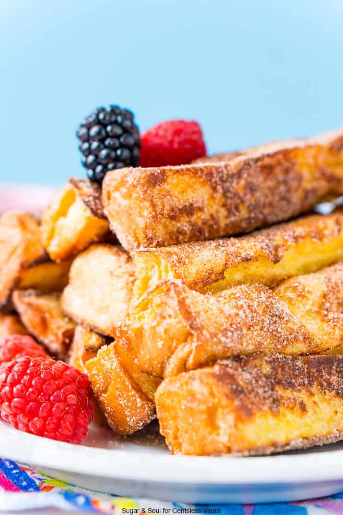 French toast sticks on a plate with berries