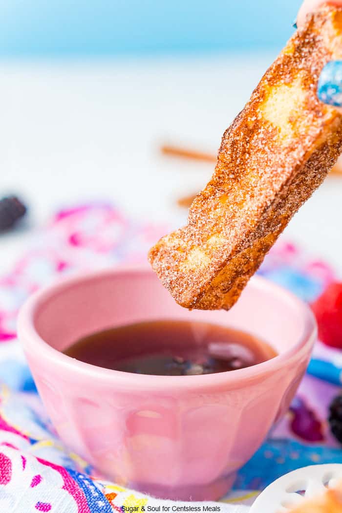 French toast stick with a bowl of syrup