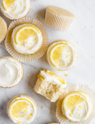 Lemon cupcakes on a marble board, some have icing