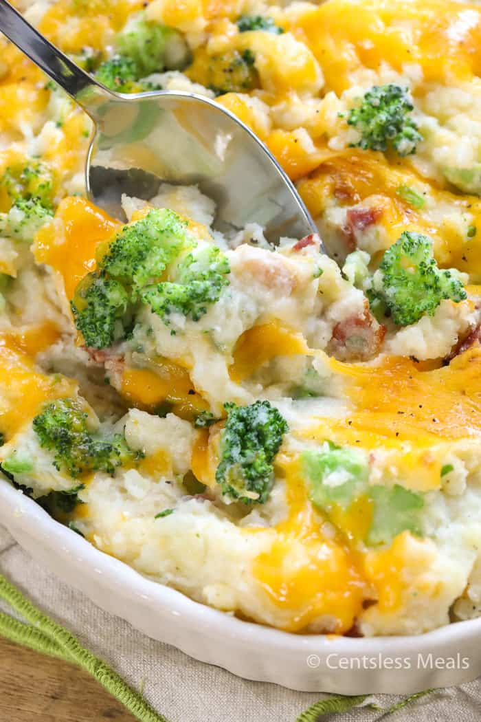 Broccoli potato casserole in a dish with a spoon