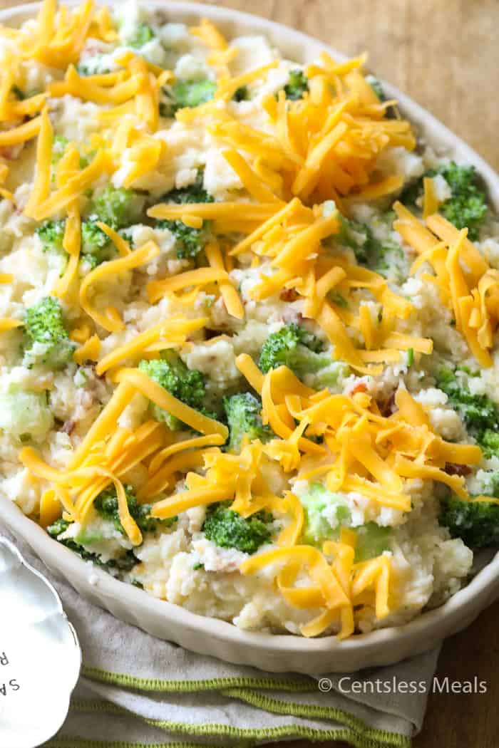 Uncooked broccoli potato casserole in a white casserole dish