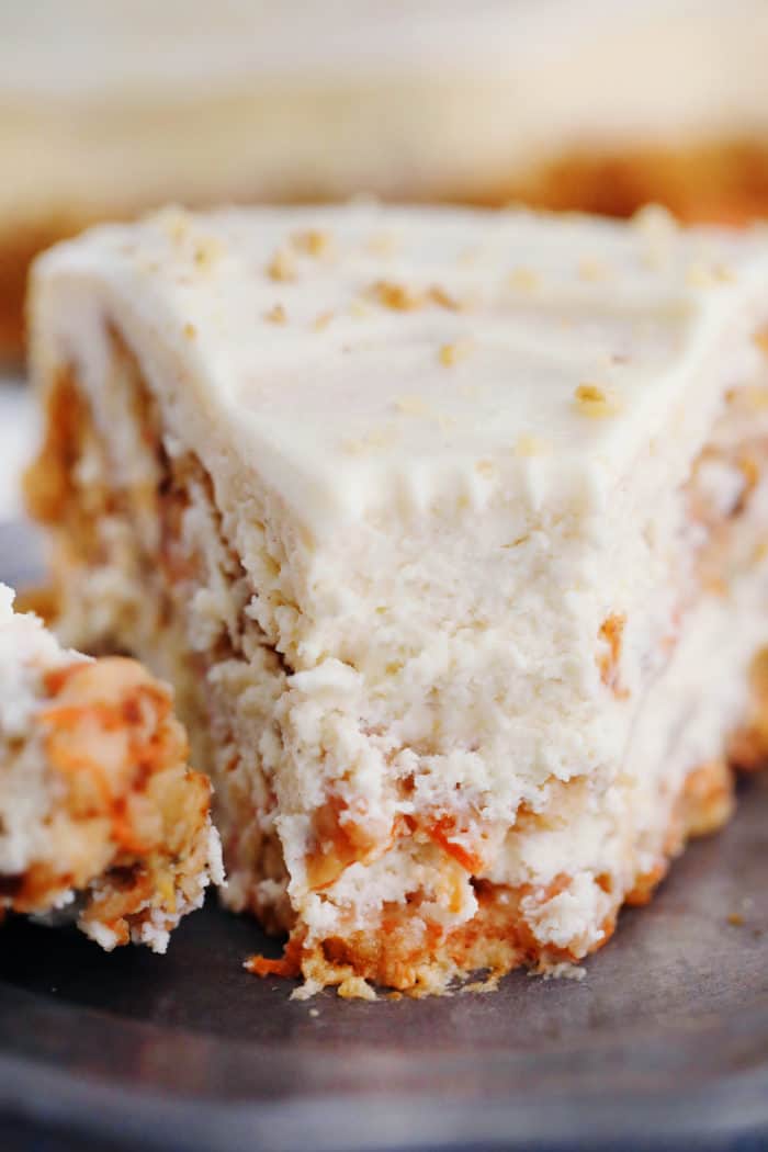 Carrot Cake Cheesecake on a plate with a bite on a fork