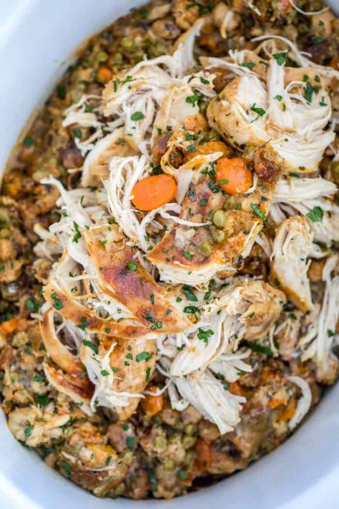 Crockpot Chicken and Stuffing in a crockpot garnished with parsley