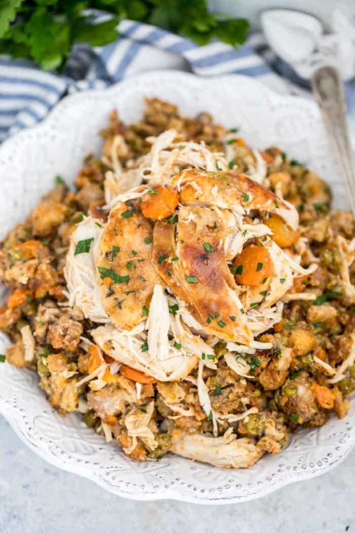 Crockpot Chicken and Stuffing on a plate with a fork garnished with parsley