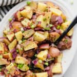 German Potato Salad in a serving Bowl garnished with green onions