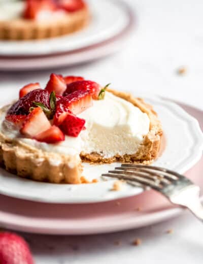 Strawberry mini tarts on plates with a fork