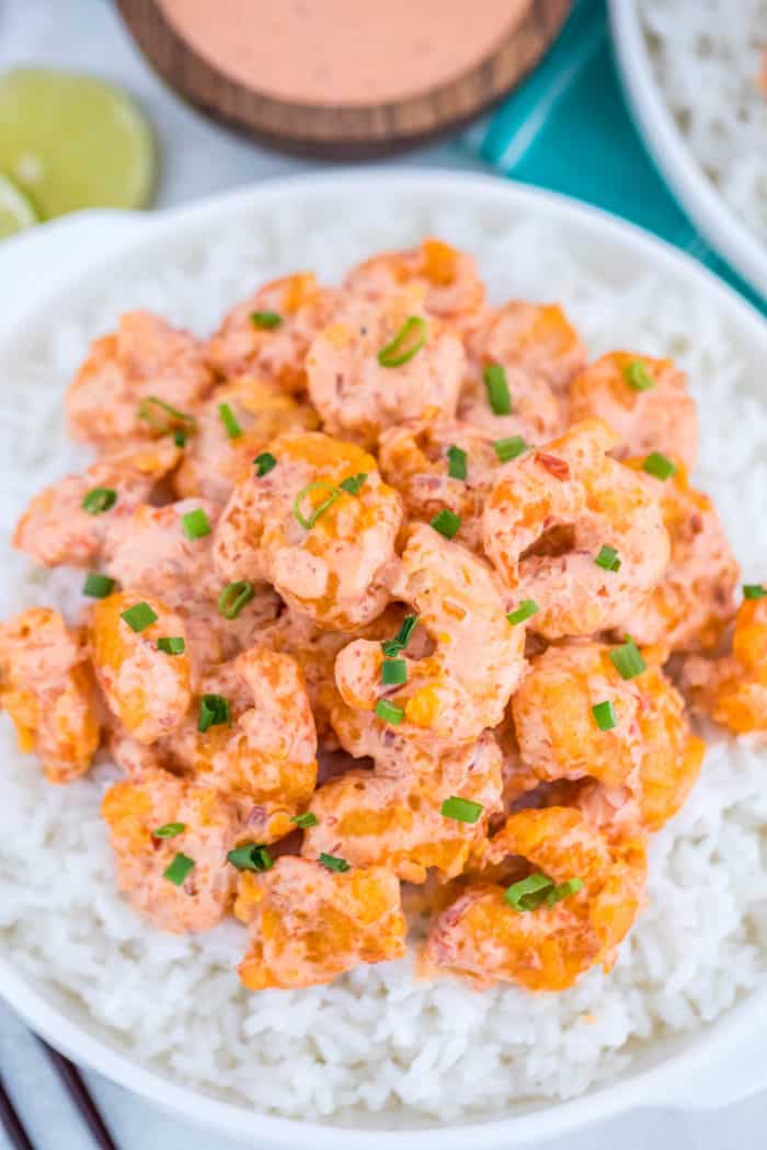 Bang Bang Shrimp on a bed of rice garnished with green onions