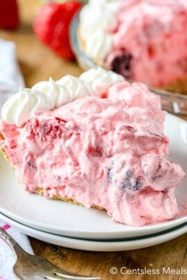 Berry fluff pie on a plate with whipped cream