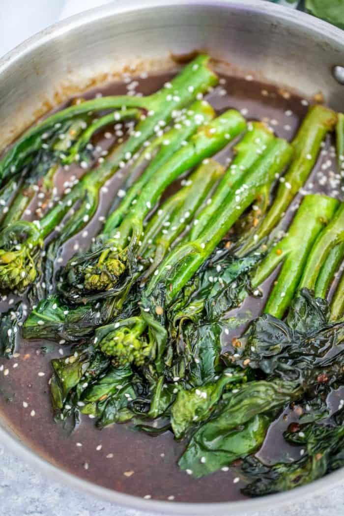 Chinese Broccoli in a pan garnished with sesame seeds