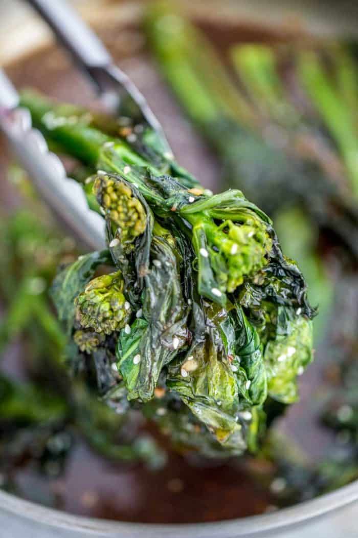 Chinese Broccoli being picked up by tongs