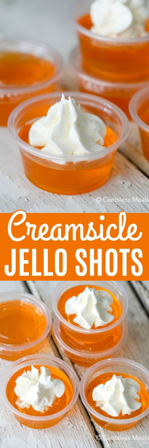 Creamsicle jello shots on a wooden board with a title