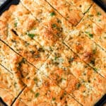 Pizza dough breadsticks on a pizza sheet with parsley