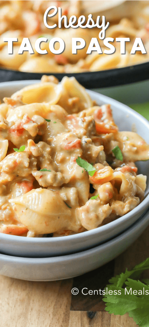 Cheesy taco pasta in a bowl with a title